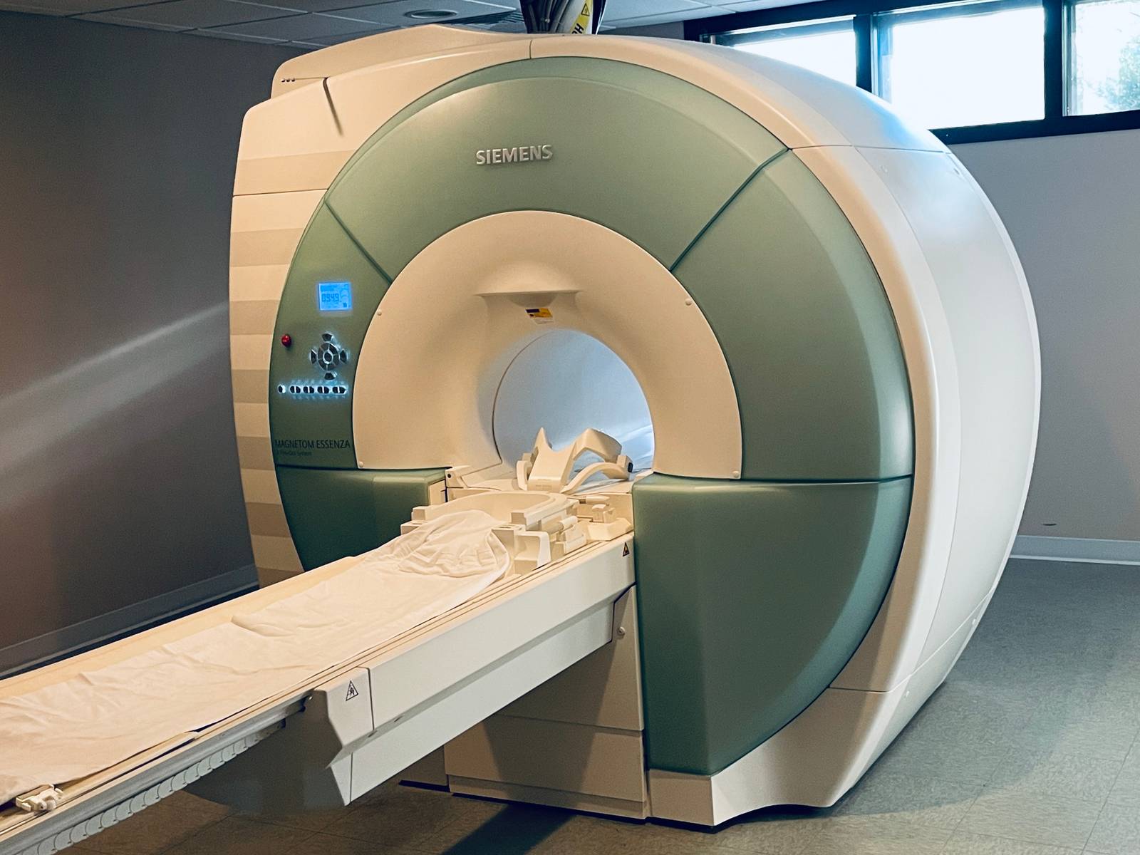 The Siemens MAGNETOM Essenza 1.5T MRI scanner in the Clarus Imaging scan room, lit by natural window light.